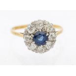 An Edwardian sapphire and diamond 18ct gold cluster ring, comprising a central round mixed cut