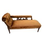 A Victorian chaise longue with back rail, on casters, along with a pair of Arts & Crafts-style