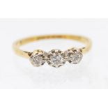 A diamond and 18ct gold three stone ring, comprising three illusion set  brilliant cut diamonds,