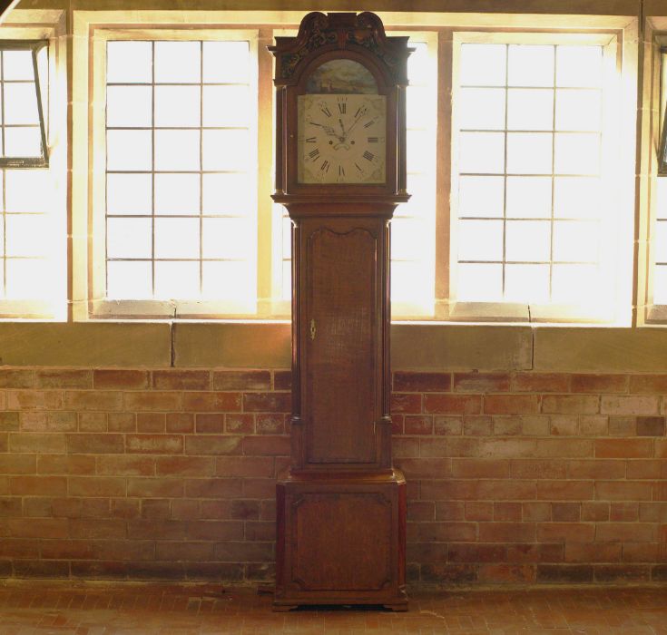 An arched enamel dial grandfather clock of VIII day duration striking on a bell in a oak case by