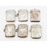 Six various early 20th Century silver vesta cases, engraved decoration on suspension chains, four