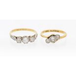 Two diamond and 18ct gold three stone rings, to include one set with graduated round cut diamonds,