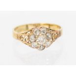 A diamond and gold ring, comprising a flower cluster of old cut diamonds, setting approx 8mm,