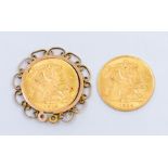 Two George V gold half sovereigns, both dated 1914 and a 9ct gold sovereign ornate mount / holder,