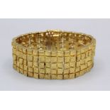 A Brutalist 18ct gold bracelet cuff hallmarked by Alan Martin Gard, London, 1972, with 19 panels