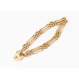 A 9ct rose gold gate bracelet comprising polished and textured links, width approx 8mm, padlock