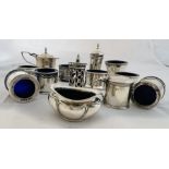 A collection of blue glass lined sterling silver tableware. COnsisting of two pepperettes, three