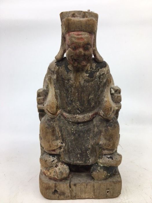 A Chinese carved wooden figure of a deity. H:21cm