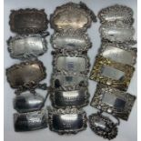 A collection of sterling silver and white metal bottle labels Featuring sherry, gin, whisky, port,