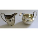 A 19th century silver cream jug of baluster shape with bright cut Greek key band and reeded scroll