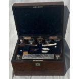 A 19th cent Rosewood vanity box with fully fitted Silver mounted bottles