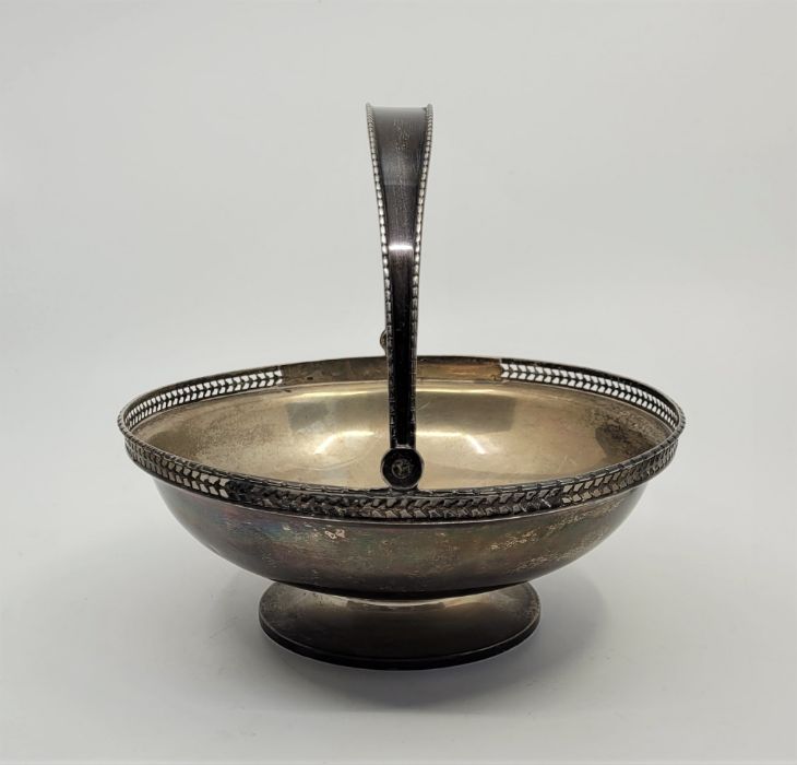 A silver swing handled pedestal basket, by Wilson & Gill, Birmingham 1914, having pierced rim, - Image 2 of 2
