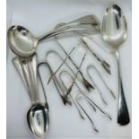 A collection of sterling silver flatware. To include a pair of sauce ladles, a serving spoon, a