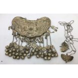 A Sino-Tibetan white metal ceremonial necklace, having central hollow panel repousse dragons and