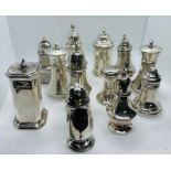 A collection of 12 sterling silver pepperettes. Largely late 19th and early 20th century examples.