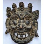 A 19th cent Sino Tibetan wooden carved mask