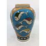 An Iznik earthenware vase, polychrome decorated with panels of fish and flowers, height 21cm.