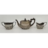 A silver three piece bachelors tea service, by John Edward Wilmot, Birmingham 1904, of oval semi-
