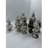 A collection of ten embossed/repousse pepperettes in sterling silver. To include examples by the