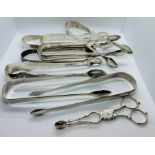 A selection of 18th and 19th century sugar tongs, along with a pair of tea tongs. The tea tongs have