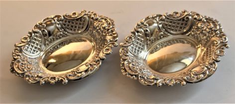 A pair of Victorian stamped silver sweetmeat dishes with foliate scrolling decoration, probably