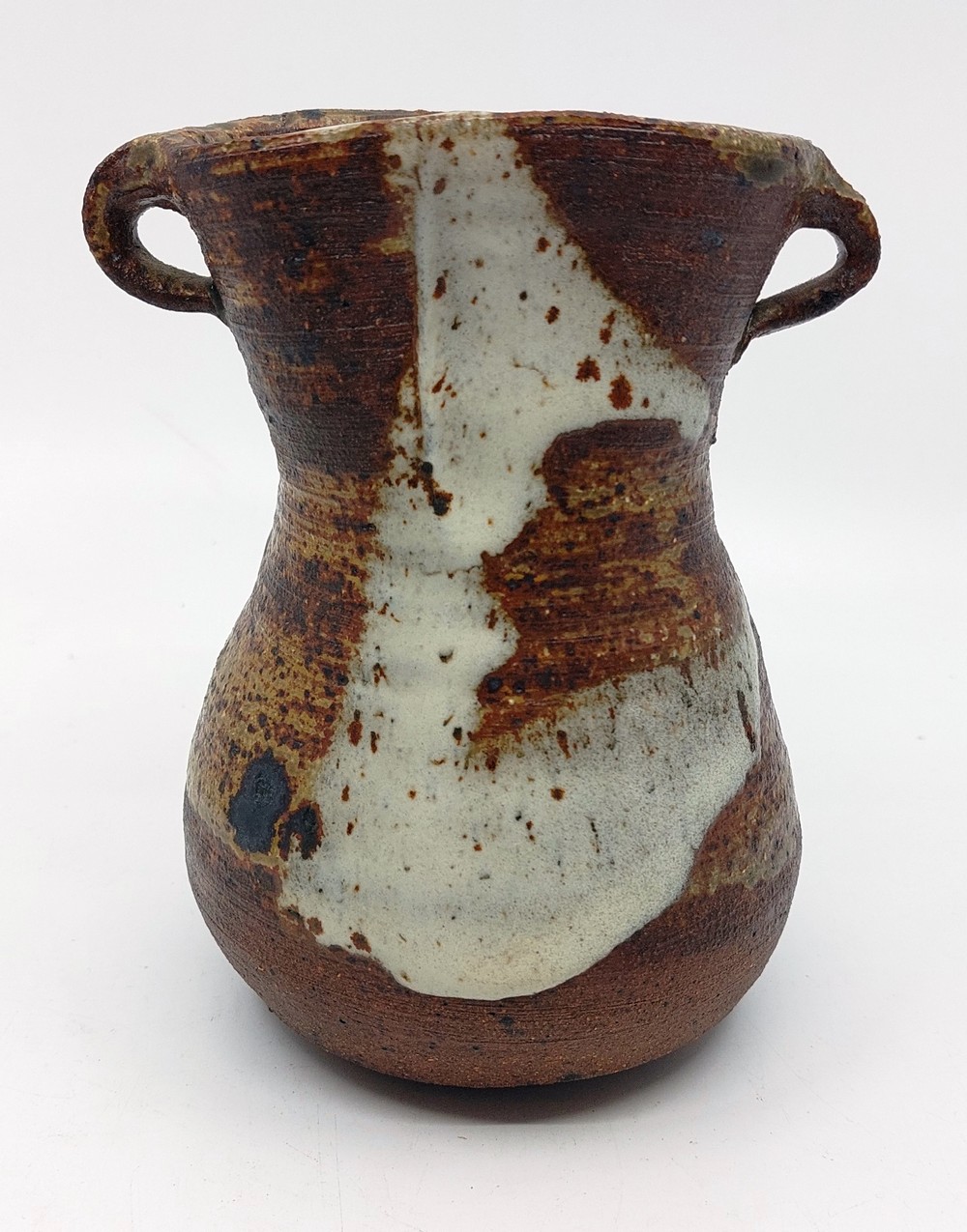 A Janet Leach (1918-1997) for Leach Pottery. Stoneware vase with twin handles. Impressed JL and