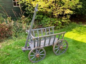 Large European dog cart.  painted grey with iron banded wheels, T bar handle controlling a movable