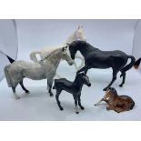 Three Beswick white horses, a Beswick dapple grey horse, a Beswick black horse and a further horse