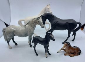 Three Beswick white horses, a Beswick dapple grey horse, a Beswick black horse and a further horse