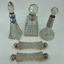 A cut glass scent bottle and stopper with engine turned enamel and silver mount, another with