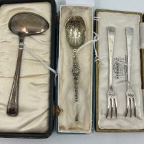 A silver gilt replica anointing spoon, Sheffield 1936, a pair of silver pickle forks, Sheffield 1934