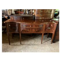 A George III style mahogany sideboard of serpentine outline, crossbanded and with line inlay, two