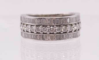 A fine Hancocks 14 brilliant cut Diamond dress ring ,with outer rows of 33 baguette cut diamonds