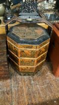 A Chinese styled three tiered handled box hexagonal shaped with brass carry handle and decorated