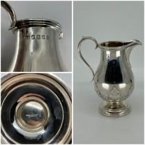 A Georgian style baluster cream jug engraved with band of stylised leaves, scroll handle, Glasgow