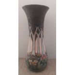 A tall tube lined stylised Moorcroft vase, decorated with a continuous band of woodland trees with