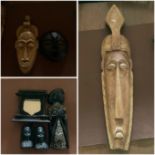 A selection of Ethnigraphica masks, a carved frame and pair of bookends