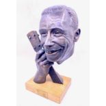 George Formby (1904-1961). A bronze bust of George Formby holding the neck of his banjo ukulele,