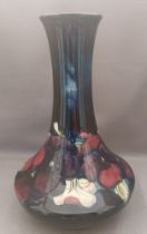 A 1947-1953 tall tube lined stylised Moorcroft vase, decorated with pansies of different colours
