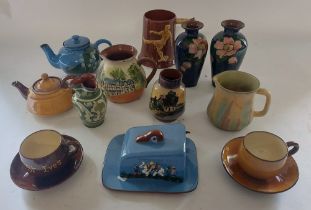 A large collection of Torquay ware to include vases, coffee pots, tea pots cups and saucers, cruet