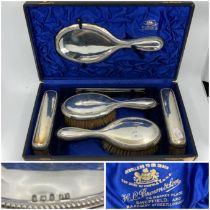An Edwardian dressing table set, the plain silver mounts with beaded borders comprising a pair of
