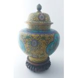 A Chinese famille jaune cloisonne baluster shaped enamel jar and domed cover, on Oriental hardwood