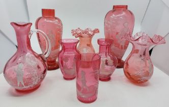 Eight pieces of Mary Gregory cranberry glass to include two baluster shaped vases, two vases with