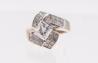 A diamond set crossover ring set with a princess cut diamond of an estimated 2.04 carats in a raised