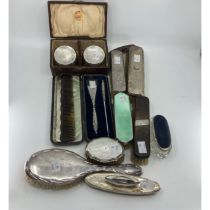 A pair of circular brushes with silver mounts, Birmingham 1925, cased, a hairbrush and three clothes