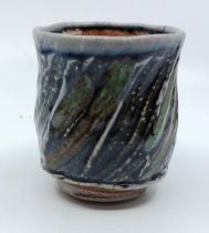 A Phil Rogers (1951-2020). Stoneware yunomi (tea cup).with stamp, the cup has a brown/green glaze.