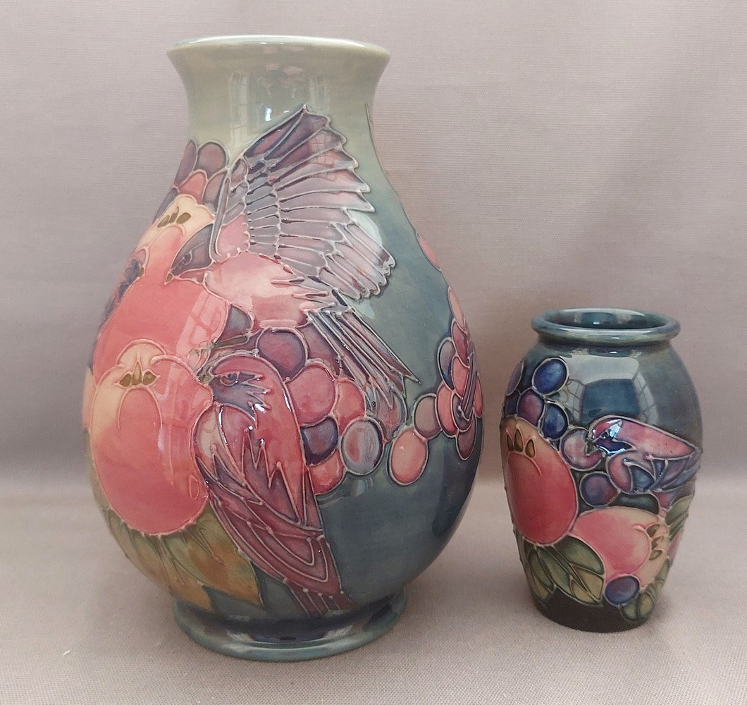 2 early tube lined stylised Moorcroft vases, decorated in the fruit and fiches pattern, with the