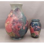 2 early tube lined stylised Moorcroft vases, decorated in the fruit and fiches pattern, with the