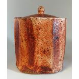 A Lisa Hammond (born 1956). Stoneware lidded tea caddy. with orange and brown glaze decoration.