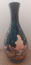 A very tall tube lined stylised Moorcroft vase, decorated with trees and landscape, with a river,
